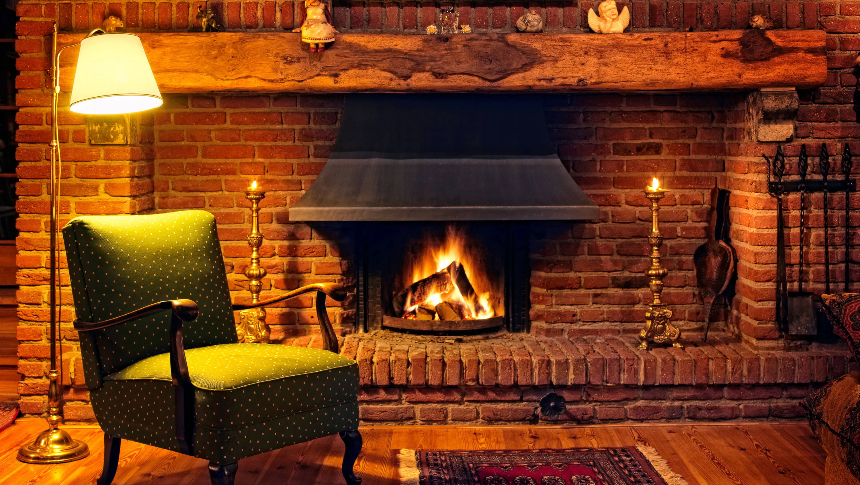 fireplace mantel with a green chair and a lamp