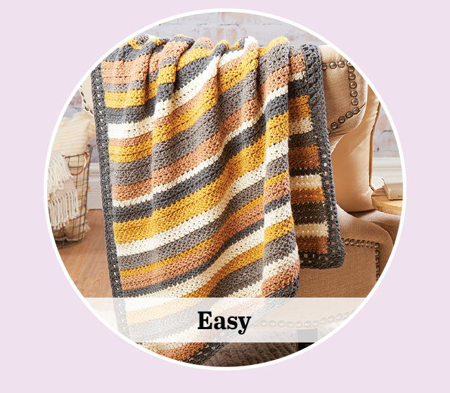 Striped blanket draped over a chair with the word 