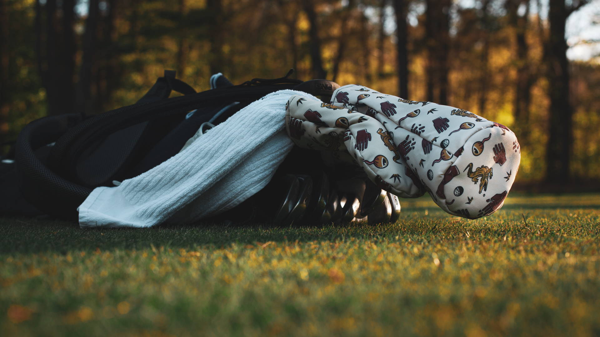golf bag laying on the ground with Chubbs themed head covers from Cayce Golf