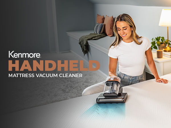 Woman using a Kenmore handheld mattress vacuum cleaner in a bright room.