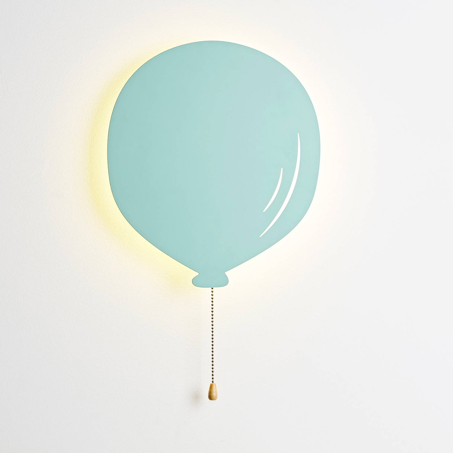 Green balloon light illuminated on wall