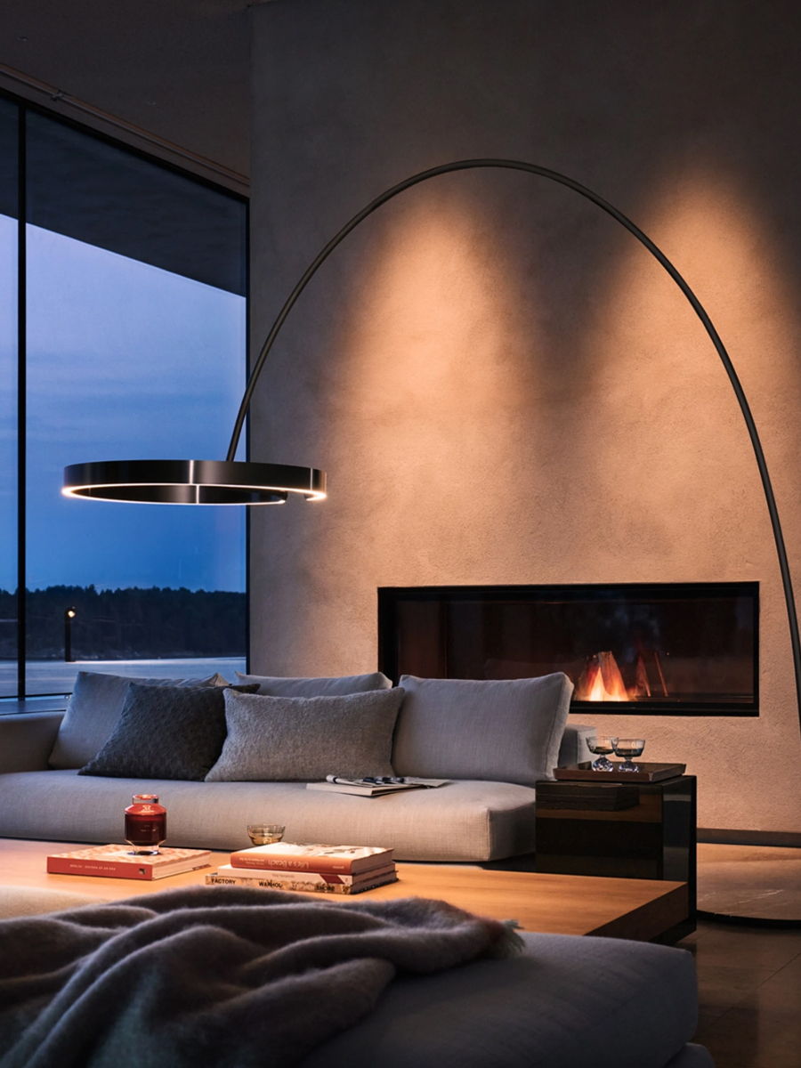 Cozy modern living room with a fireplace and stylish lighting.