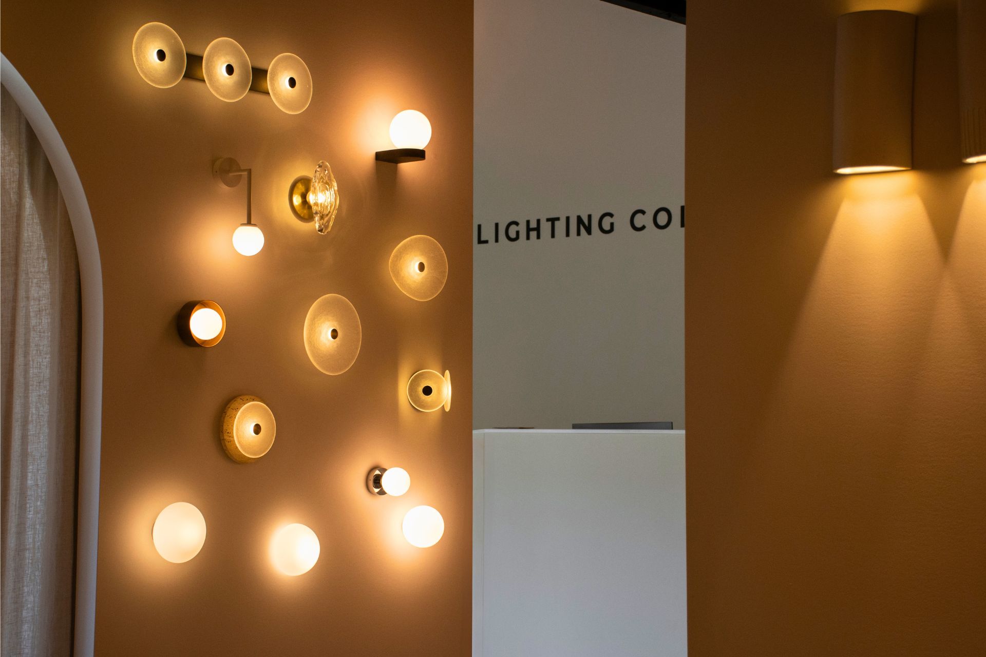 Wall display of various light fixtures in a modern setting.