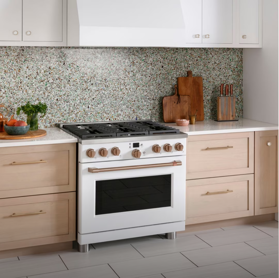 Modern kitchen with a gas range, wooden cabinets, and decorative backsplash.