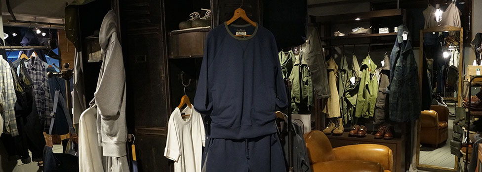 Clothing display in a retail store featuring various garments.