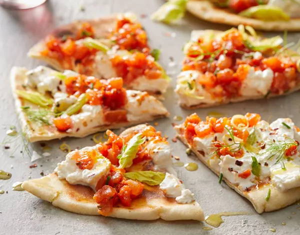 Flatbread topped with burrata cheese and tomato bruschetta