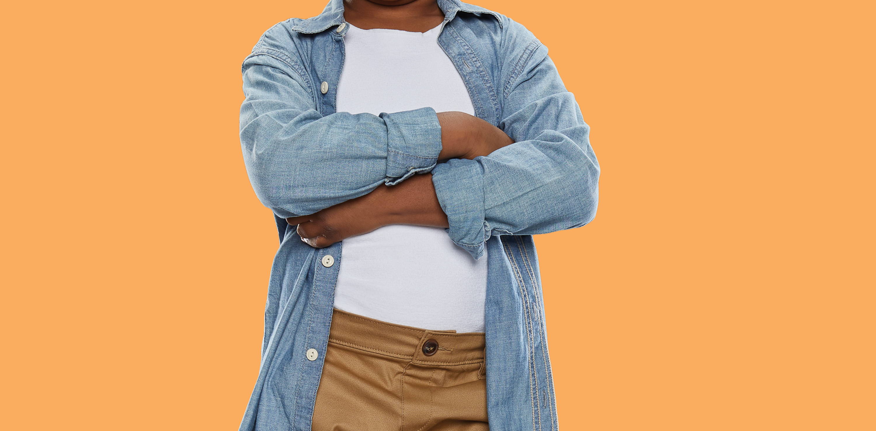 Young boy with crossed arms, boy wearing SmartKnitKIDS compresso-T under outfit