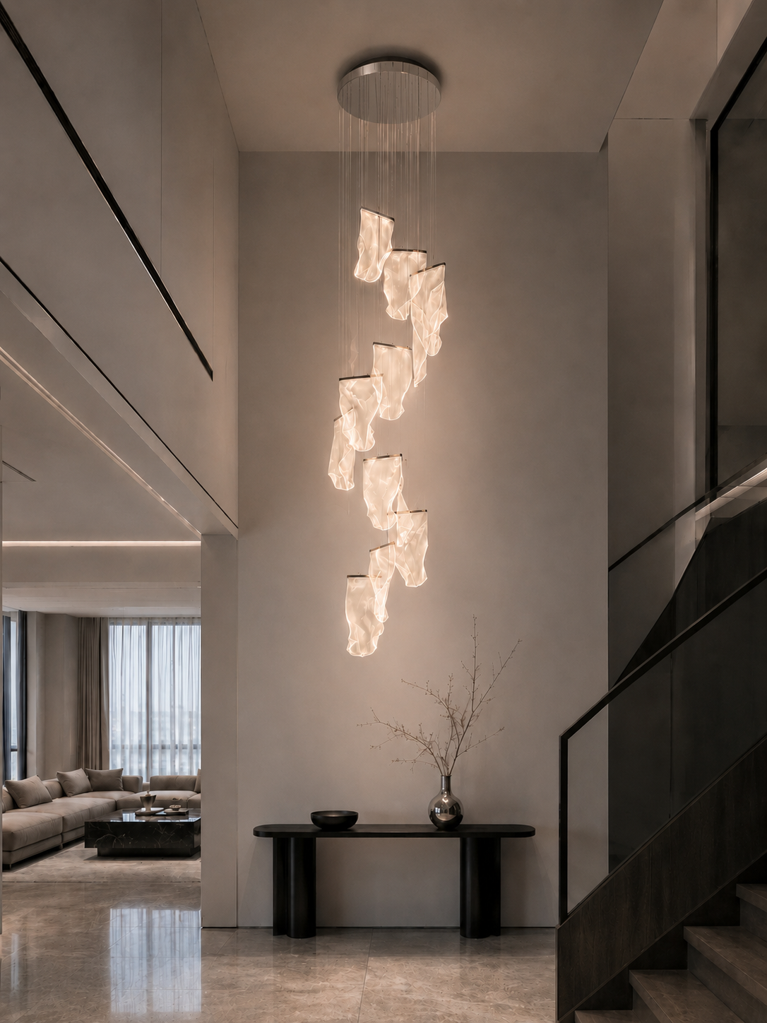 Sculptural acrylic pendant sized to a narrow double-height void beside a staircase, with a console table below