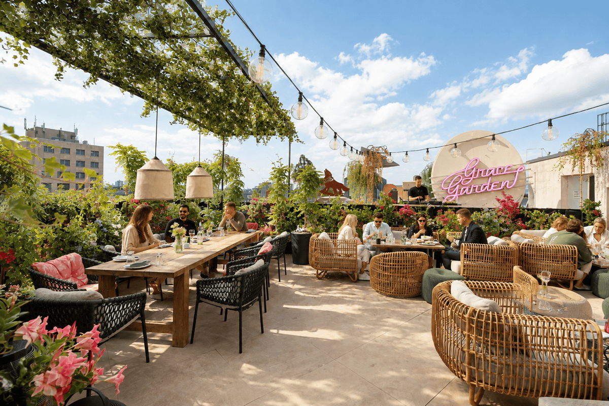 Daytime rooftop restaurant with commercial patio furniture, woven lounge seating and outdoor dining tables