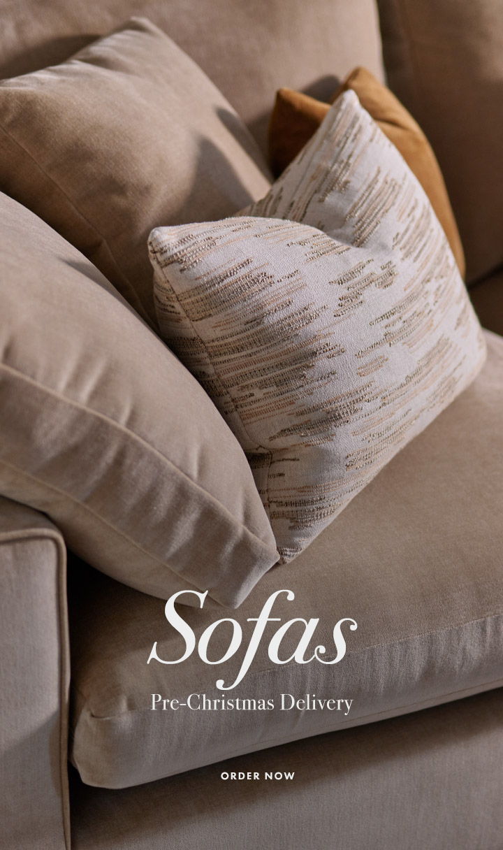 Sofas with decorative pillows, promoting pre-Christmas delivery. Order now.