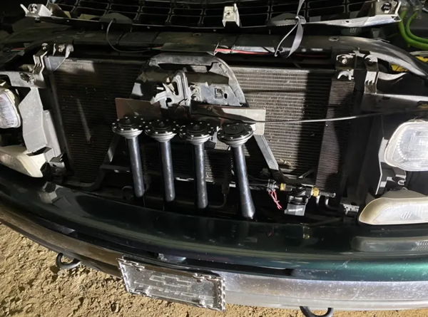 Shocker S4 train horns mounted behind the front grille of Dalton's 2001 Chevy Tahoe, install photo 3