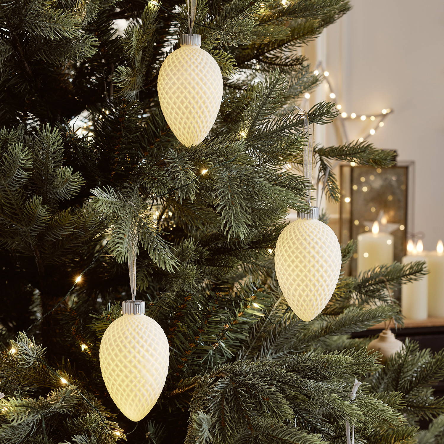 3 White LED baubles hanging from a Christmas tree.