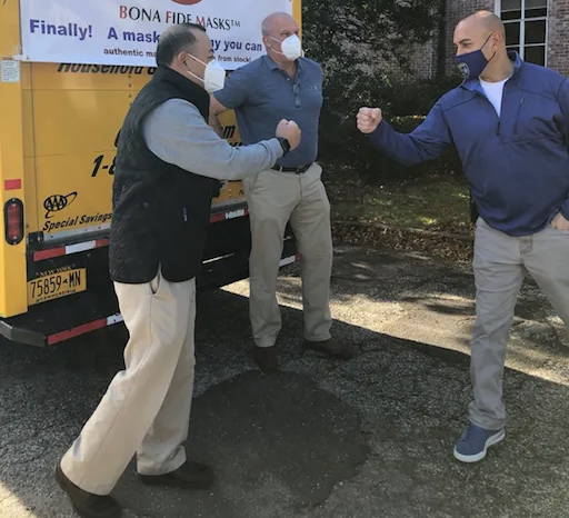 Bill and Jim Taubner of Bona Fide Masks deliver 50,000 masks that the company is donating to the New Canaan Police Department. Lt. Jason Ferraro pictured at right.