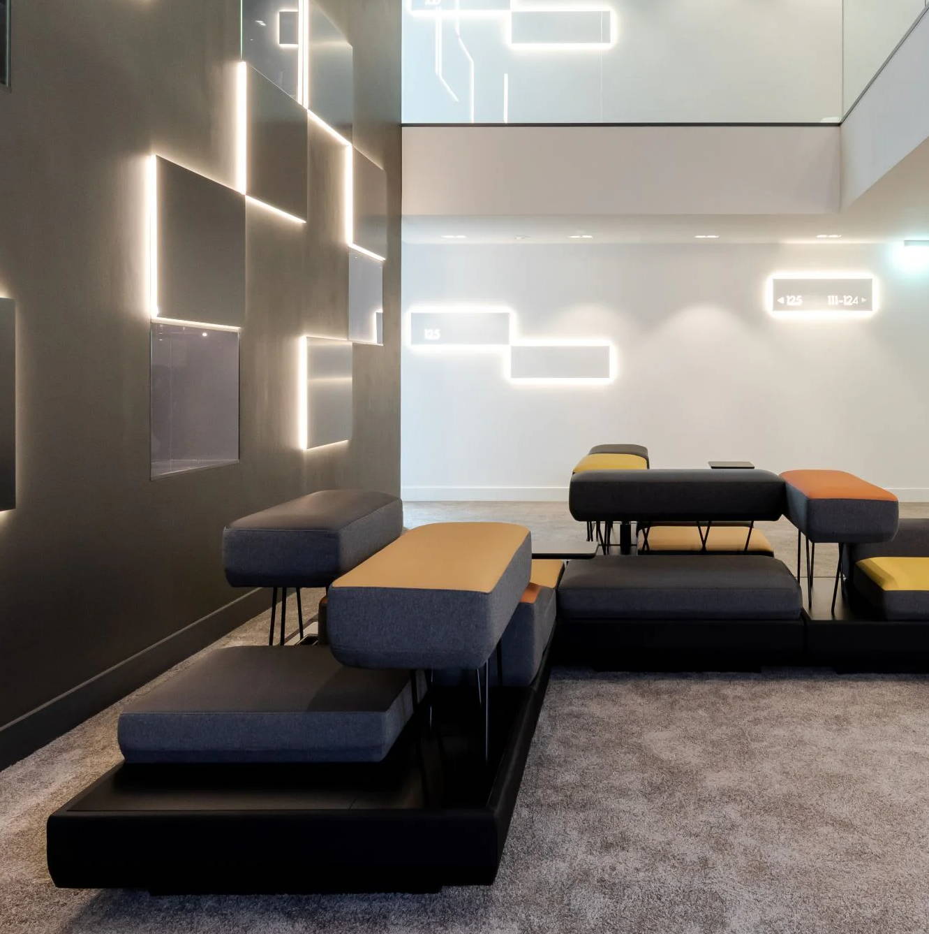 Inside KPM Hotel & Residences a modern lounge area with stylish seating and ambient lighting.