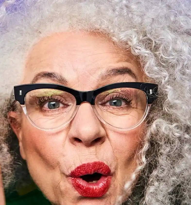 Old woman with grey hair wearing semi-rimless cat eye glasses that make you look younger