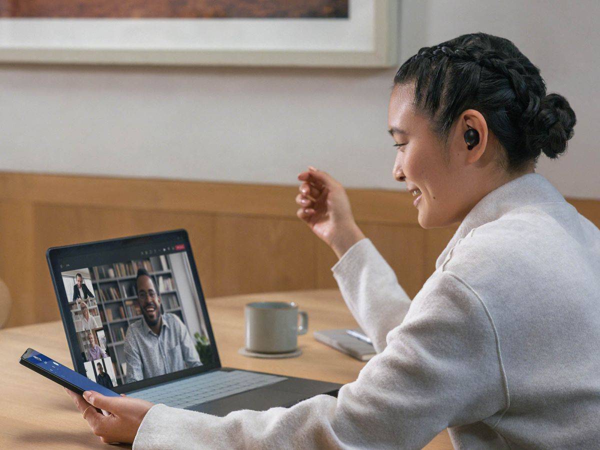 Woman making call on laptop with XM5 Buds