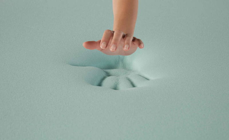 Hybrid mattress comfort layer designed to relieve pressure on shoulders and hips