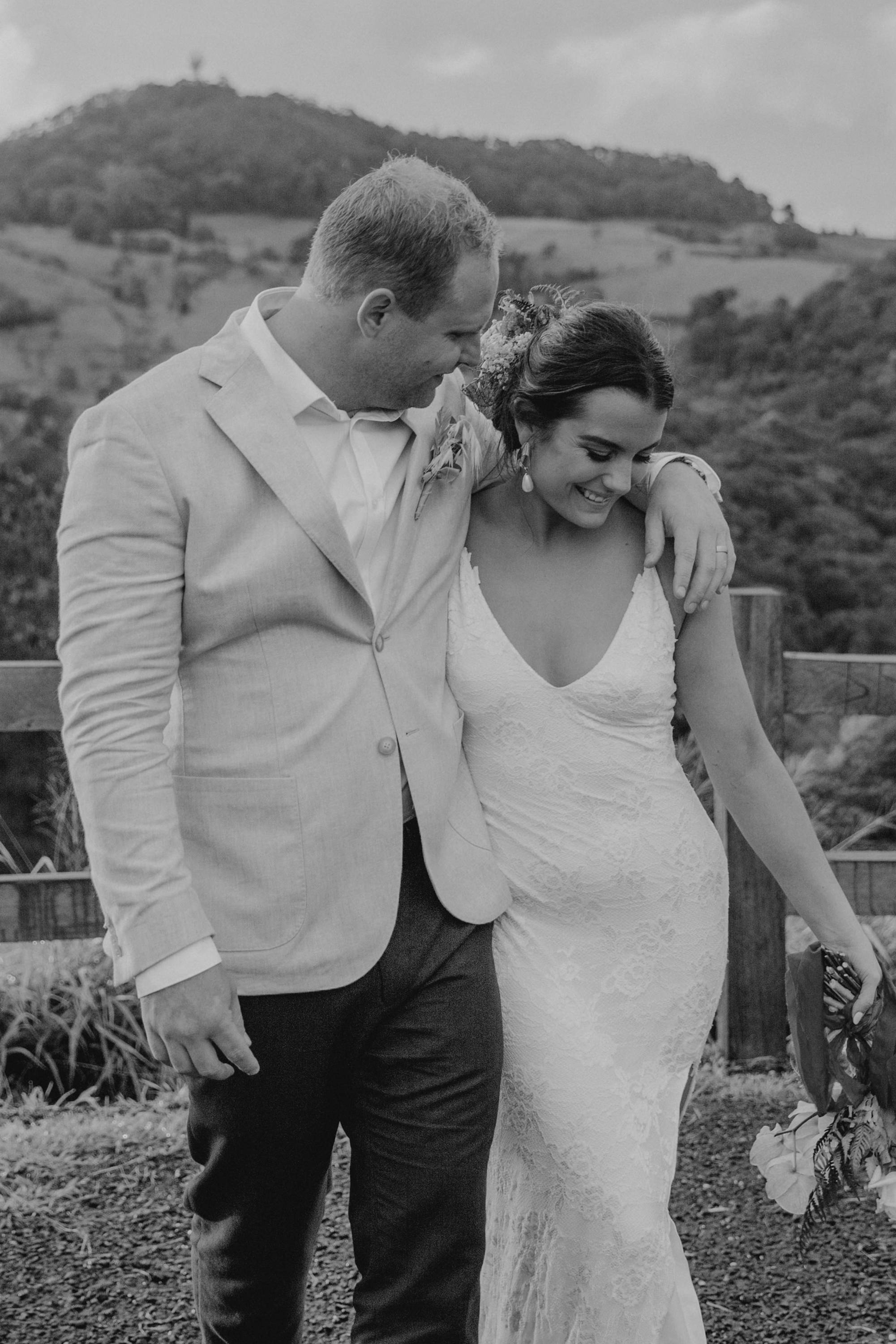 Groom with his arm wrapped around his new wife