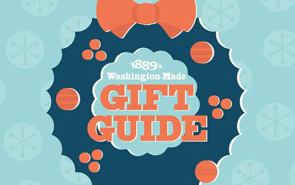 1889 Washington Made Gift Guide logo. A dark teal wreath with red bow and bobbles, light teal backdrop.