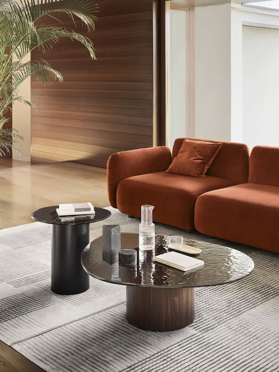 Modern Calligaris living room with a brown sofa, coffee tables, and decorative items.