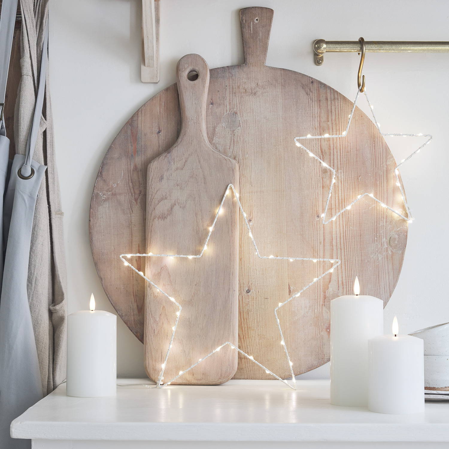 Osby stars and LED candles decoratively scattered in a minimalist kitchen setting 