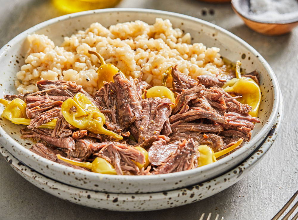 Shredded pot roast with pepperoncini in a bowl