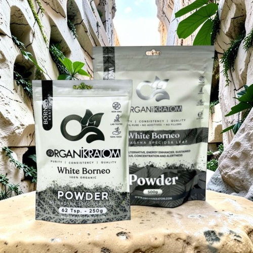 Two bags of White Borneo powder on a stone surface.