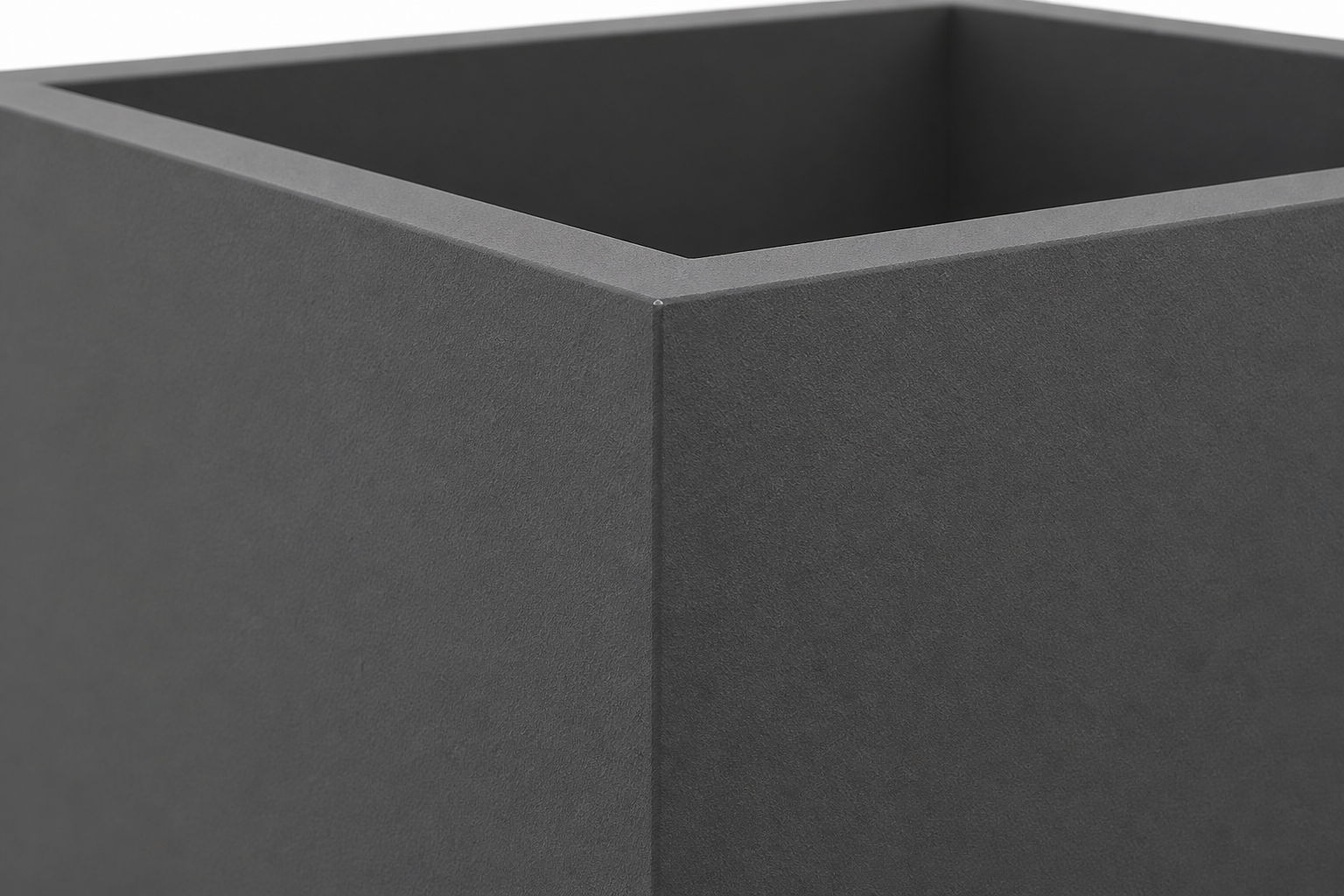 Close-up of a dark gray, square fiberglass planter with sharp edges.