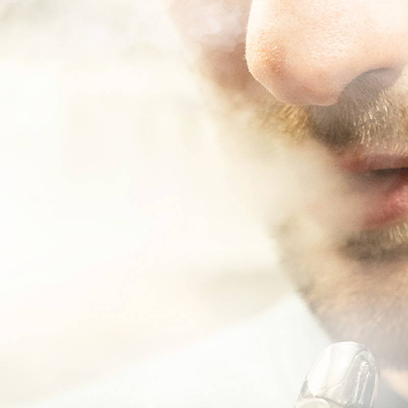 A photo showing a person exhaling vapour