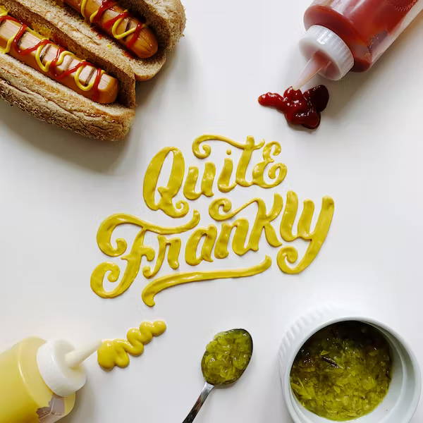 Hot dog food type art that reads Quite Frankly