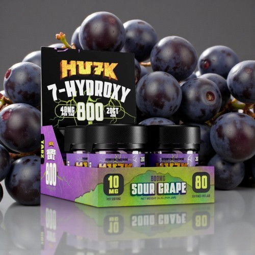 Display of product boxes with grapes in the background.