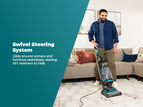 Man using a vacuum cleaner with swivel steering system in a living room.