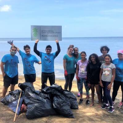 cariloha employees cleaning a beach