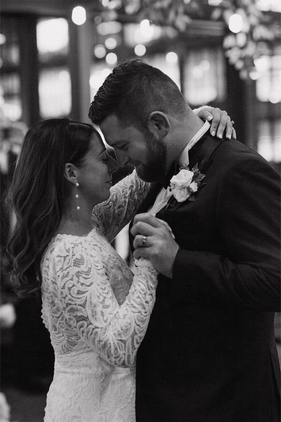 Couple dancing closely at a wedding, sharing an intimate moment.