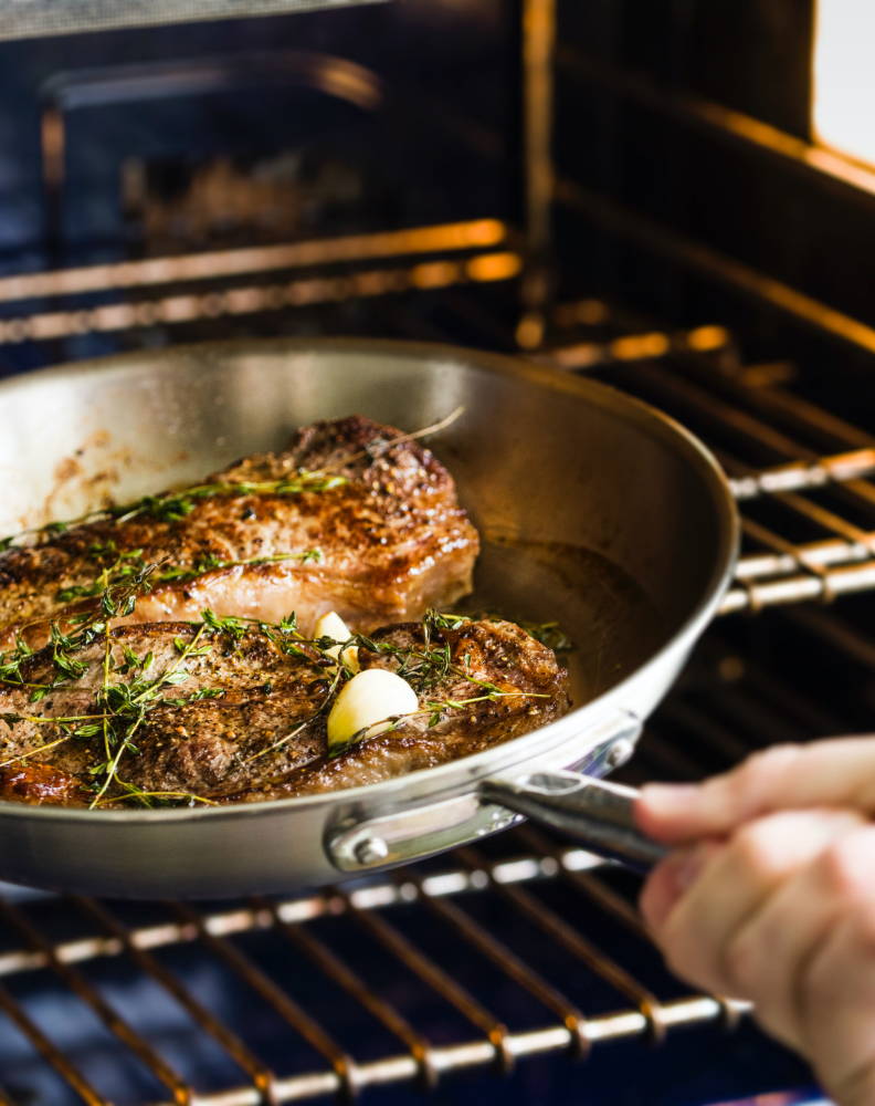 The Misen Stainless Skillet can go from stove to oven & is perfect for a variety of dishes, including rosemary garlic steak.