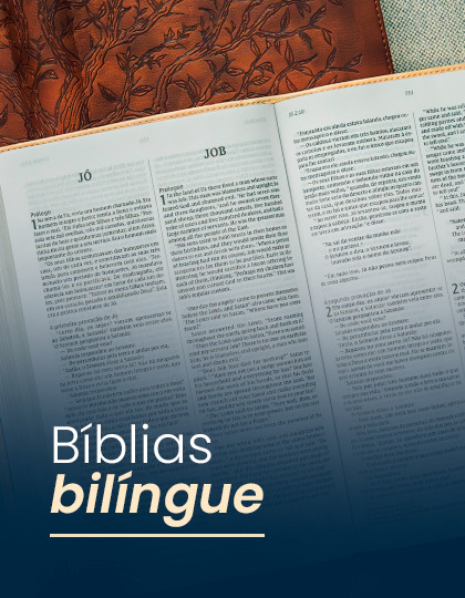 Bilingual Bibles open on a table with decorative background.