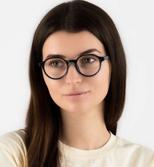 woman wearing Wonder Navy glasses, rounded soft geometric glasses for diamond faces, on a white background