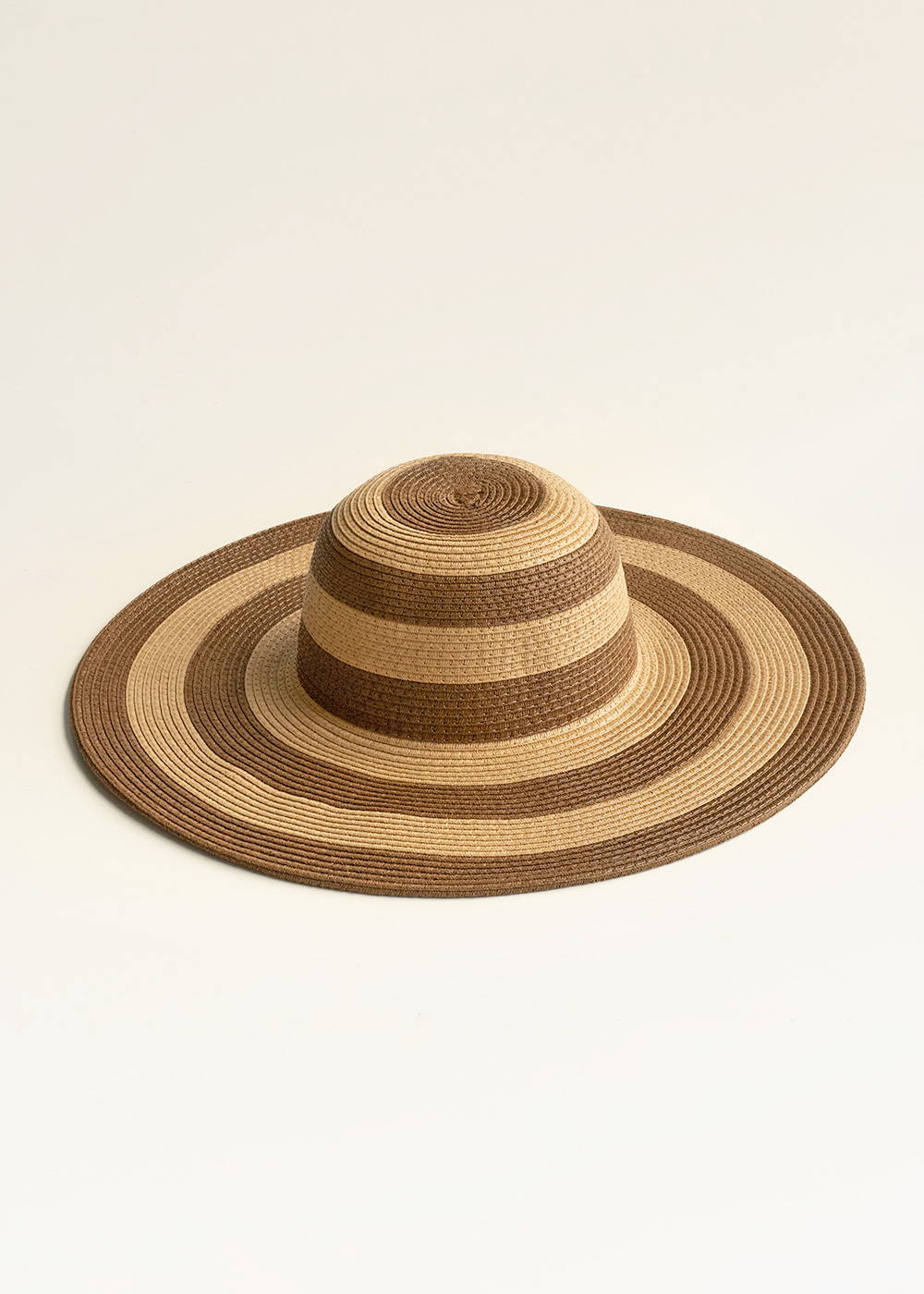 A wide brimmed sun hate with alternating brown and beige stripes