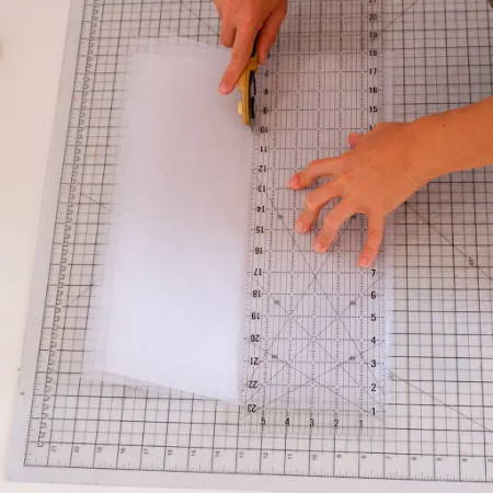 Cutting the tulle fabric in 6 inch strips with a rotary cutter and ruler