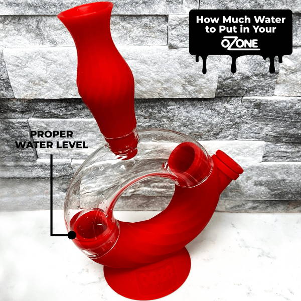 A scarlet Ooze Ozone bong is shown with a small amount of water in it. A black arrow that says FILL LINE is pointing to the water level.