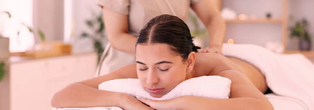 Person receiving a massage in a serene spa environment.