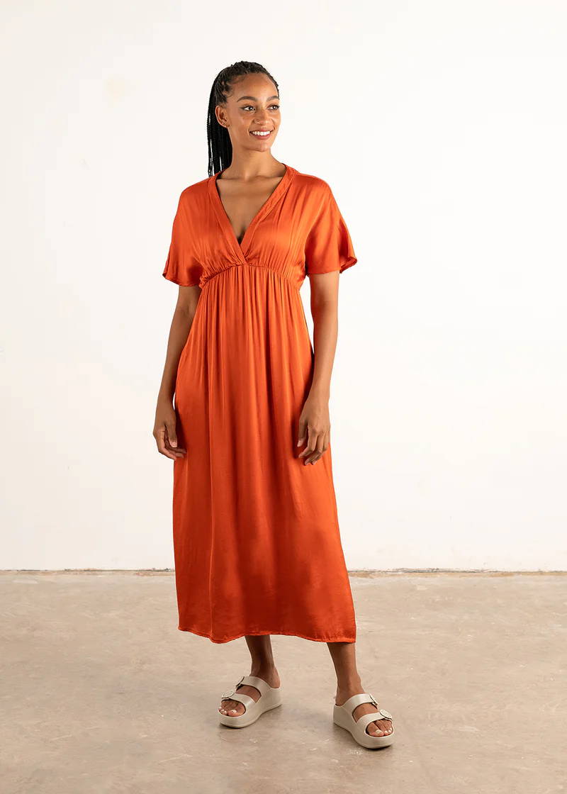A model wearing a tomato red satin midi dress with short sleeves
