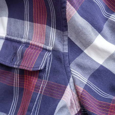 A flat felled seam on the armscye of a flannel shirt, the seam on the outside