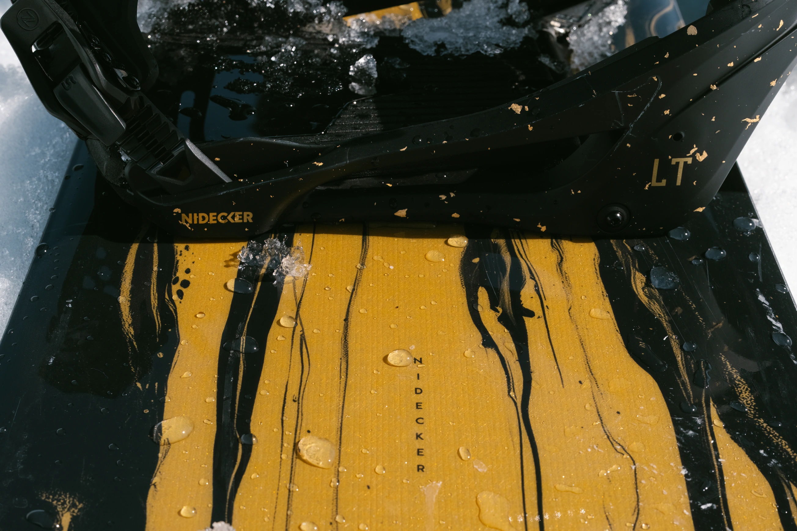 A black and yellow abstract painting with drips and textures.
