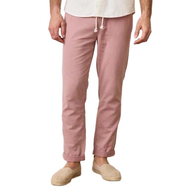 Man wearing pink pants and beige slip-on shoes.