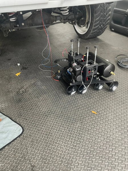 Conductor's Special 232 spare tire delete horn kit on the shop floor beneath Addison's 2015 Chevy Tahoe, install photo 5