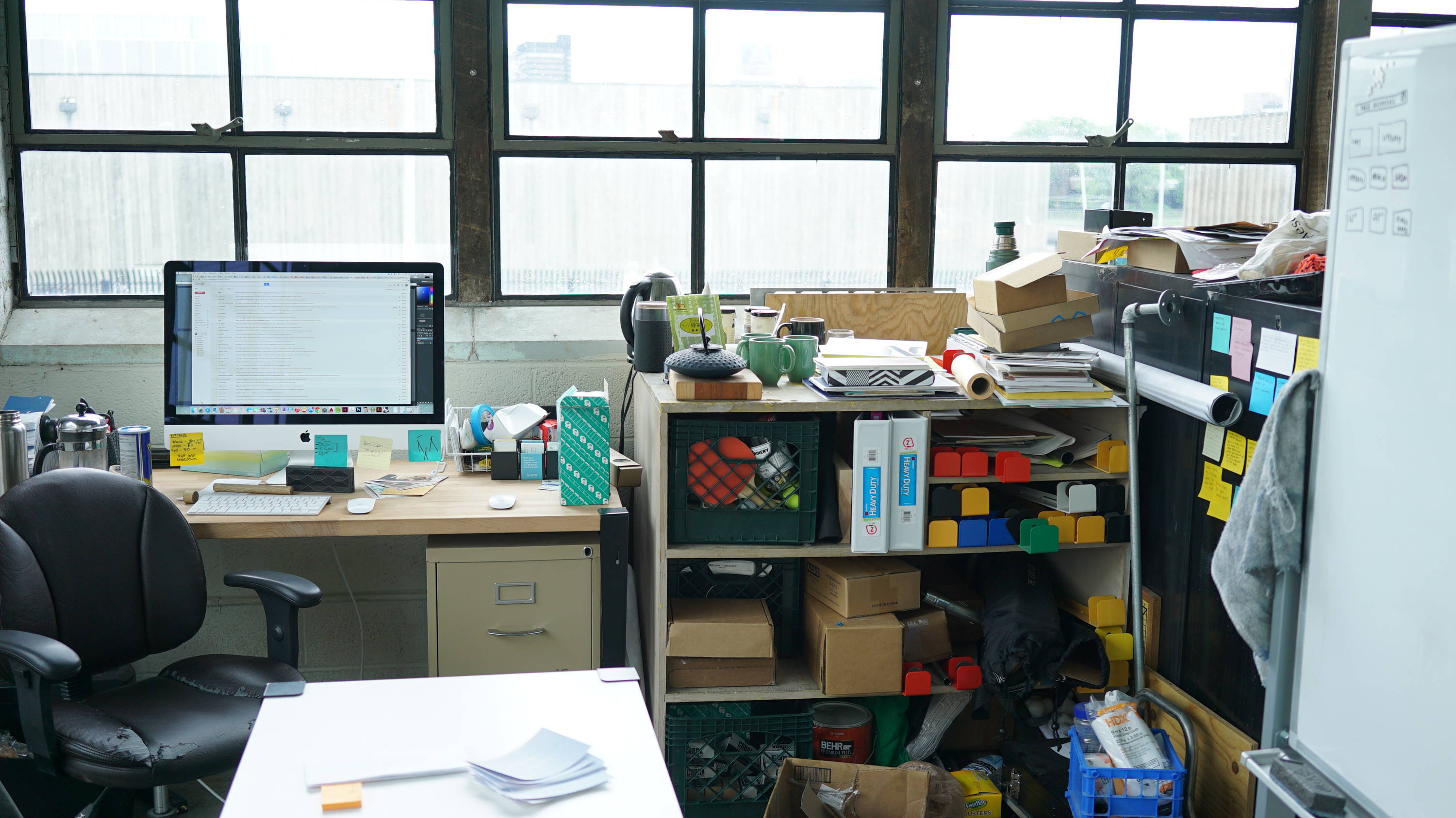 Early Floyd workspace in Detroit office with desk, shelves, and big windows