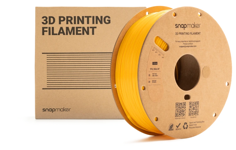 Yellow 3D printing filament spool next to its packaging.