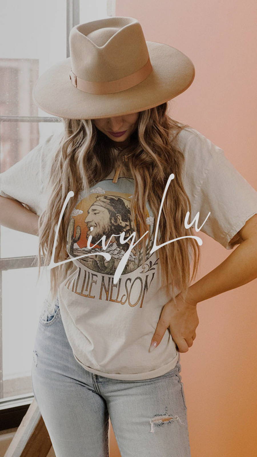 Young woman wearing Willie Nelson tee, jeans, and a brimmed hat