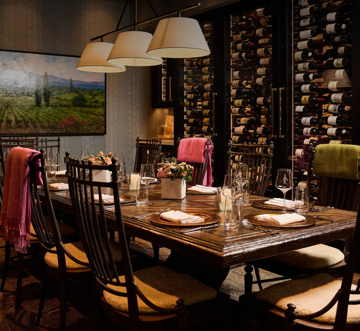 Dining room with a large table, chairs, and a wine display.